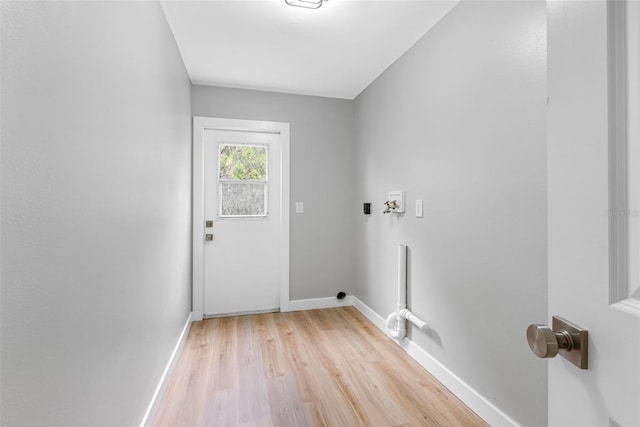 laundry area with light wood-type flooring