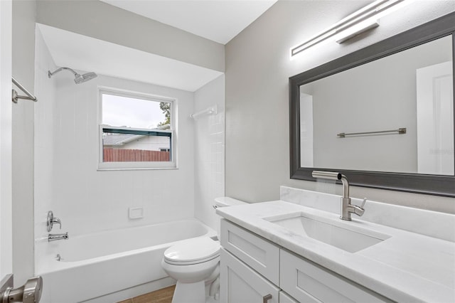 full bathroom with vanity, tiled shower / bath combo, and toilet