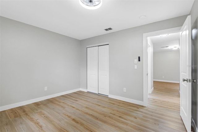 unfurnished bedroom featuring a closet and light hardwood / wood-style flooring