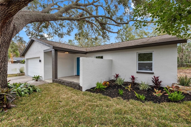 view of front of house featuring a garage and a front lawn