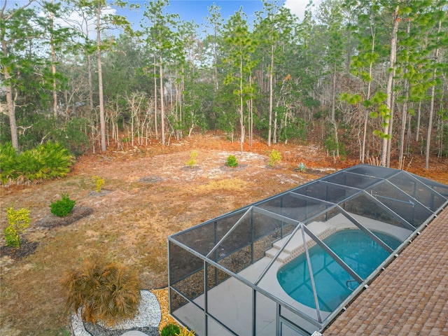 view of pool with glass enclosure