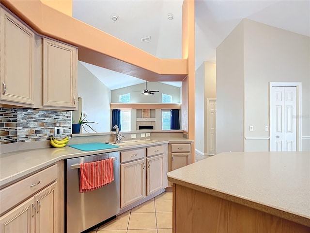 kitchen with lofted ceiling, backsplash, stainless steel dishwasher, light tile patterned floors, and ceiling fan