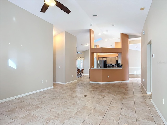 unfurnished living room with lofted ceiling, light tile patterned floors, and ceiling fan