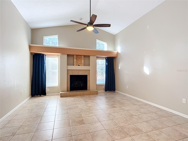 unfurnished living room with ceiling fan, a fireplace, high vaulted ceiling, and light tile patterned floors