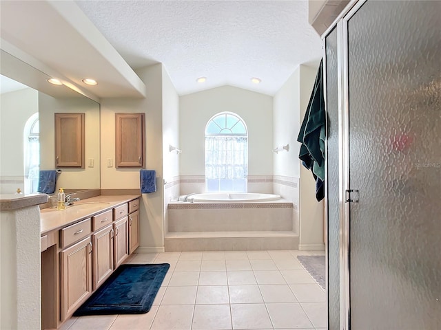 bathroom with separate shower and tub, vaulted ceiling, a textured ceiling, vanity, and tile patterned flooring