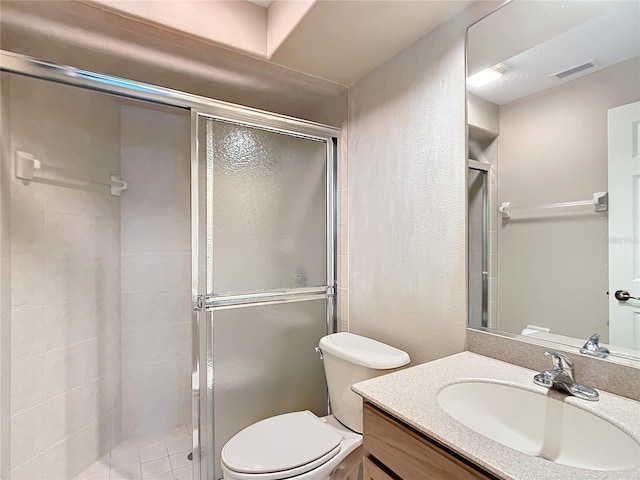 bathroom featuring vanity, toilet, and walk in shower