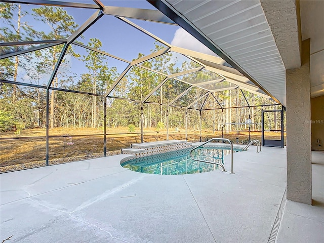 view of swimming pool featuring a patio area and glass enclosure