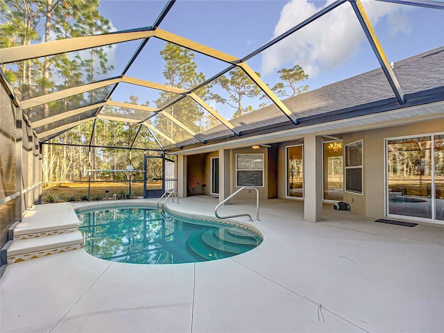 view of swimming pool featuring a lanai and a patio area