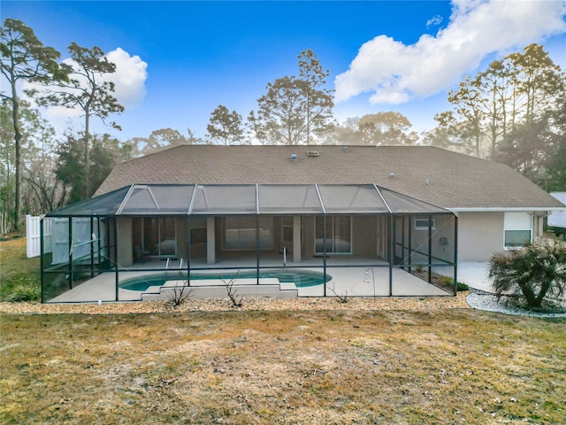 back of house with a patio area, a lawn, and glass enclosure