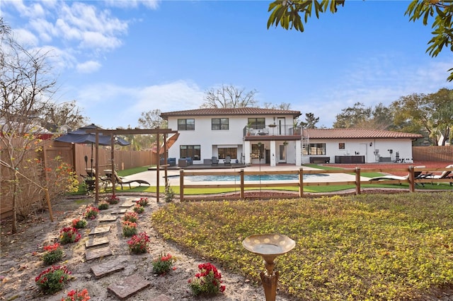 back of house with a yard, a pergola, a patio, and a balcony