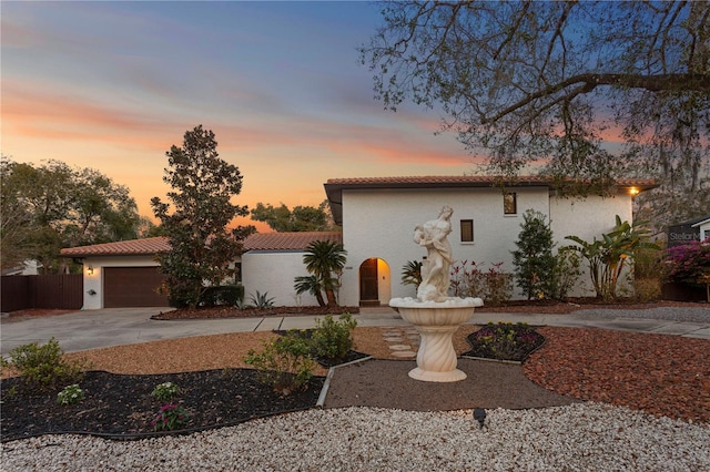 mediterranean / spanish home featuring a garage