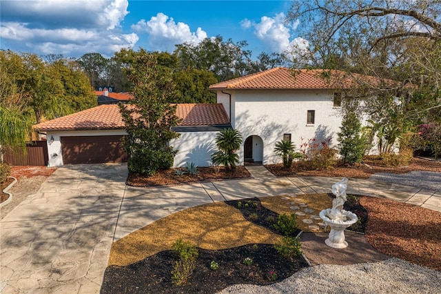 mediterranean / spanish house with a garage