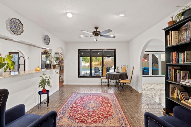 living area with ceiling fan