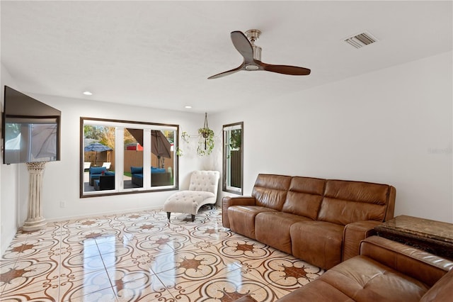 tiled living room with ceiling fan