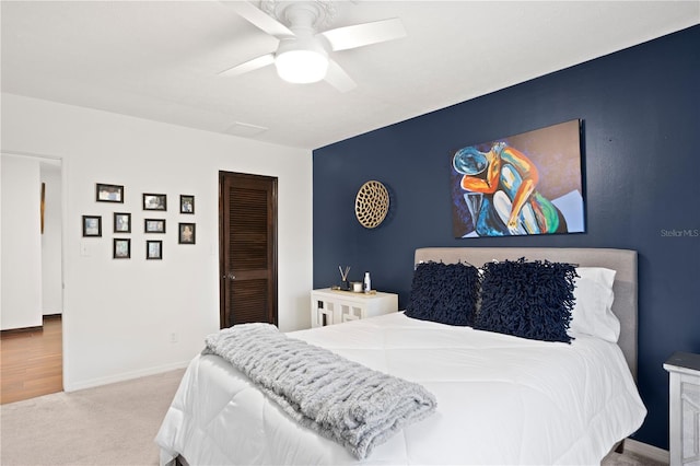 bedroom with light carpet, a closet, and ceiling fan