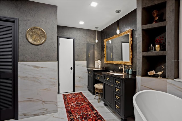 bathroom featuring vanity and a bath