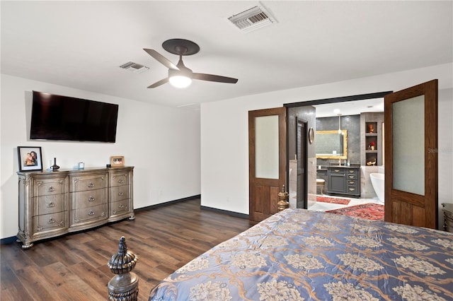 bedroom with ceiling fan, dark hardwood / wood-style floors, and ensuite bath