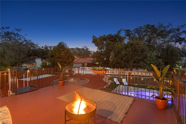 patio terrace at dusk with an outdoor fire pit