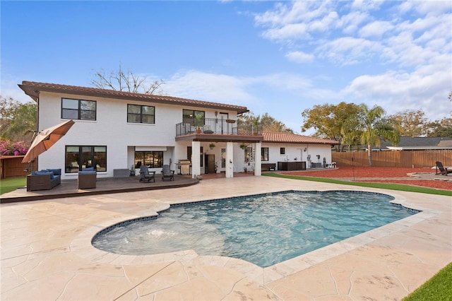 back of property featuring a fenced in pool, a patio, a balcony, and central air condition unit