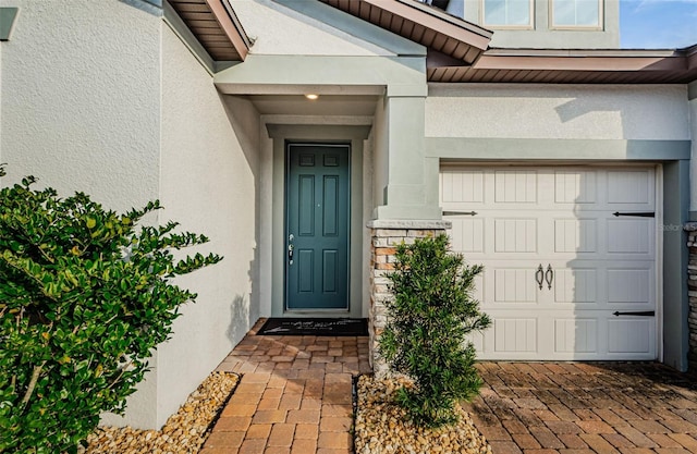 doorway to property with a garage