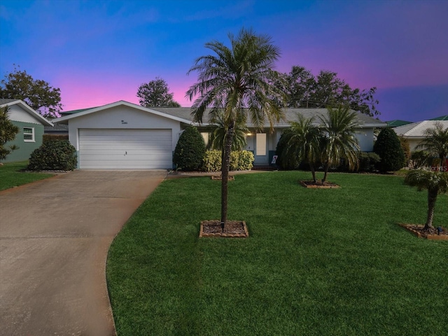 view of front of house with a garage and a lawn