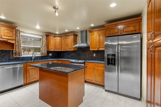 kitchen featuring a kitchen island, tasteful backsplash, sink, stainless steel appliances, and wall chimney exhaust hood