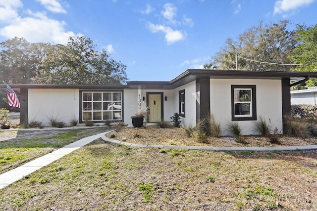 ranch-style house with a front lawn