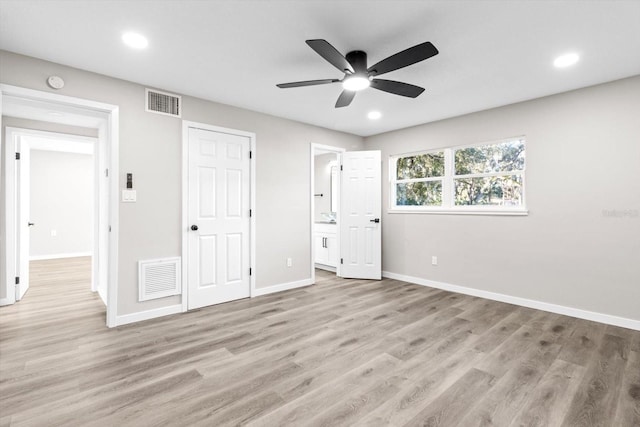 unfurnished bedroom with connected bathroom, light hardwood / wood-style flooring, and ceiling fan