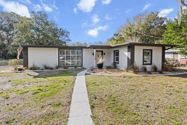 ranch-style home with a front yard