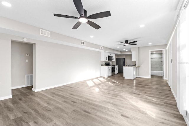 unfurnished living room with light hardwood / wood-style floors