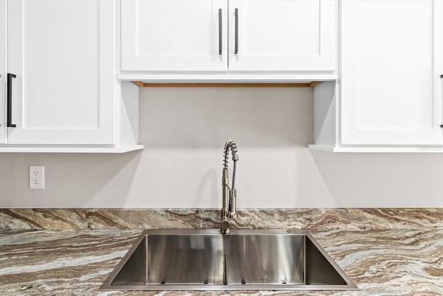 details with white cabinetry and sink