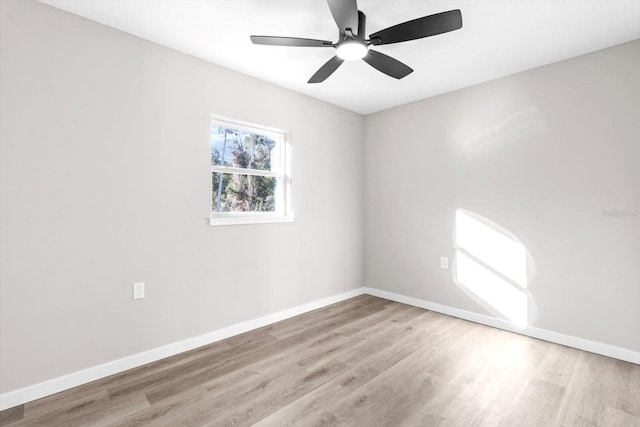 empty room with ceiling fan and light hardwood / wood-style flooring