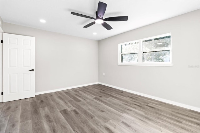 unfurnished room with ceiling fan and hardwood / wood-style floors