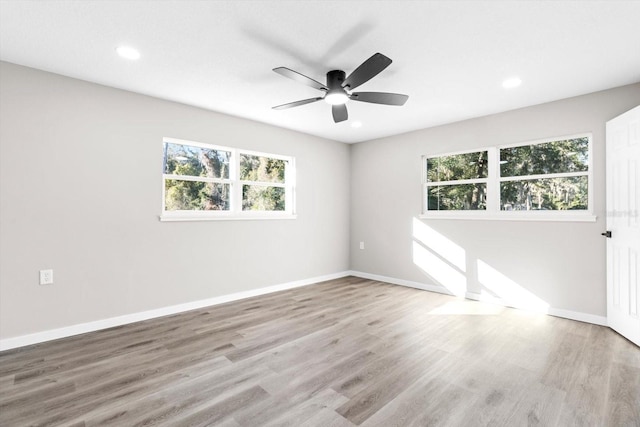 spare room with ceiling fan and light hardwood / wood-style flooring