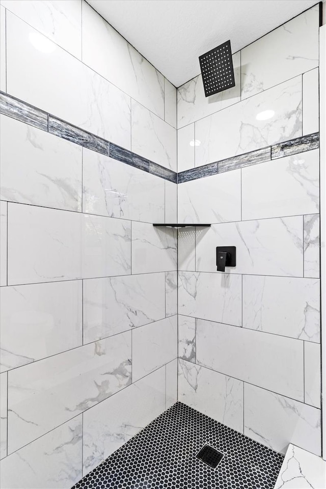 bathroom with tiled shower