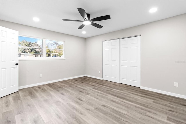 unfurnished bedroom with a closet, ceiling fan, and light hardwood / wood-style flooring