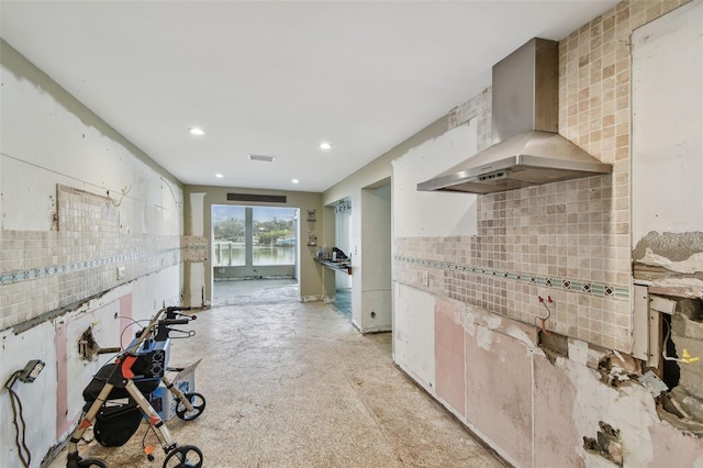 kitchen with wall chimney exhaust hood and decorative backsplash