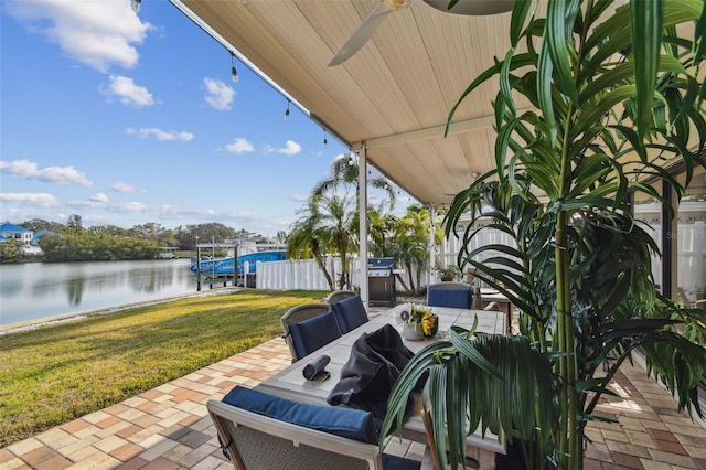 view of patio / terrace with grilling area, a water view, and ceiling fan