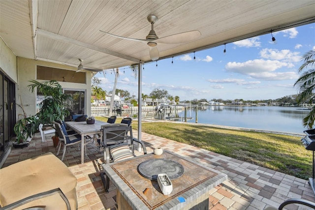 view of patio / terrace with ceiling fan and a water view