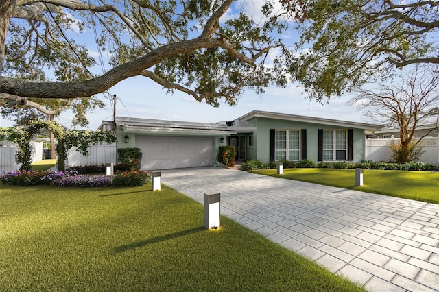 1897 Clearwater Harbor Dr, Largo, FL 33770 - ranch-style house with driveway, an attached garage, fence, a front yard, and stucco siding