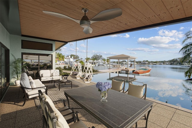 1897 Clearwater Harbor Dr, Largo, FL 33770 - view of patio featuring a dock, outdoor lounge area, outdoor dining space, a water view, and ceiling fan