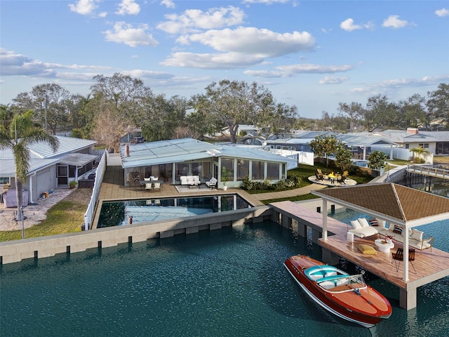 1897 Clearwater Harbor Dr, Largo, FL 33770 - dock area featuring boat lift, an outdoor pool, a residential view, and a patio