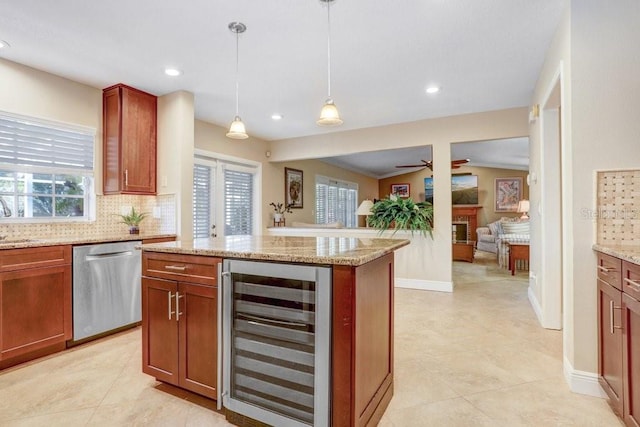 kitchen featuring decorative light fixtures, dishwasher, backsplash, wine cooler, and light stone counters