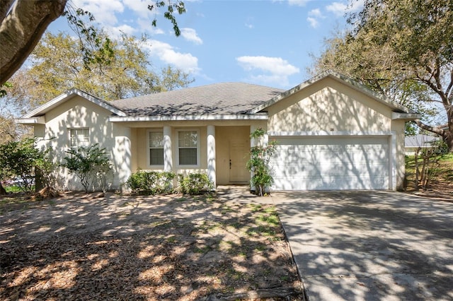 single story home featuring roof with shingles, driveway, and an attached garage