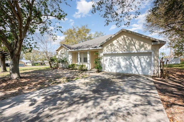 ranch-style house featuring driveway and an attached garage