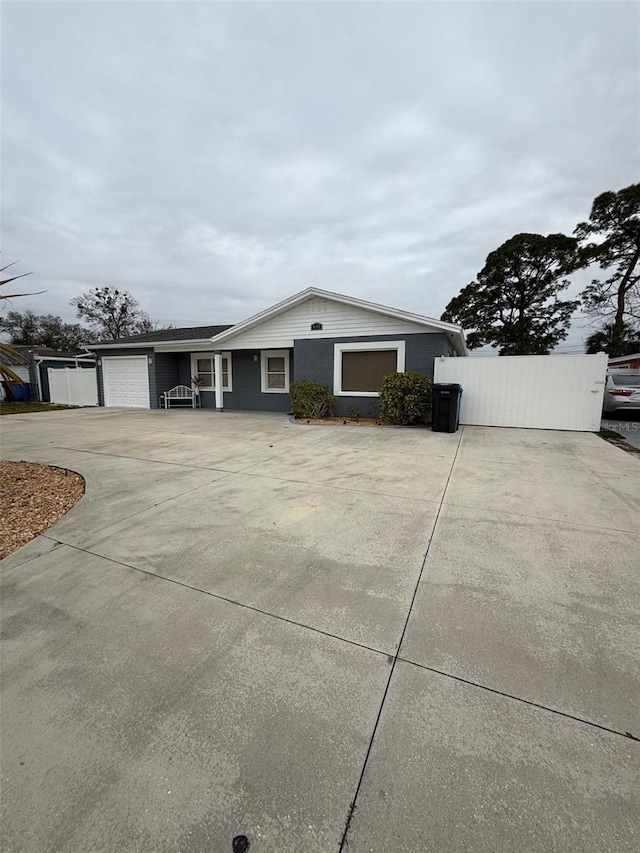 ranch-style home featuring a garage