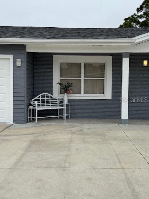 view of exterior entry with a porch