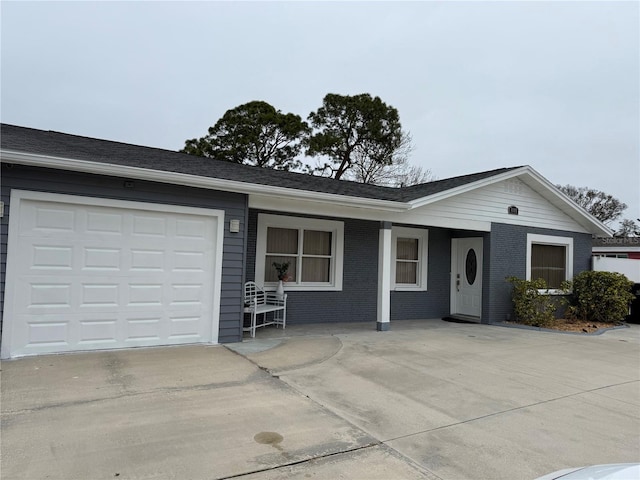 single story home featuring a garage and a porch