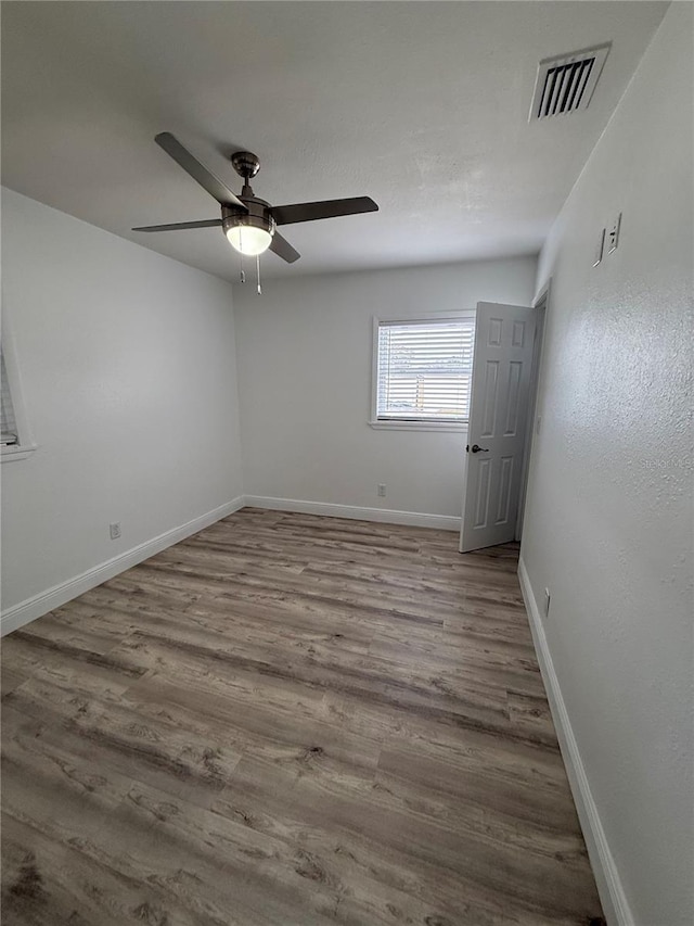 spare room featuring ceiling fan and light hardwood / wood-style flooring