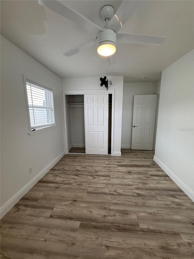 unfurnished bedroom with ceiling fan, a closet, and light hardwood / wood-style flooring